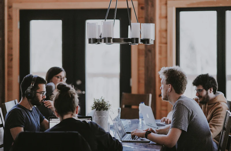 A project team in discussion around a table in a meeting room