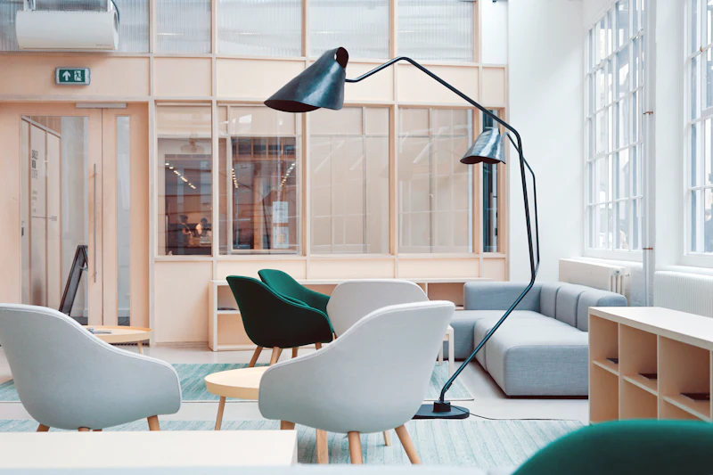 A breakout lounge with low armchairs and a slatted screen behind